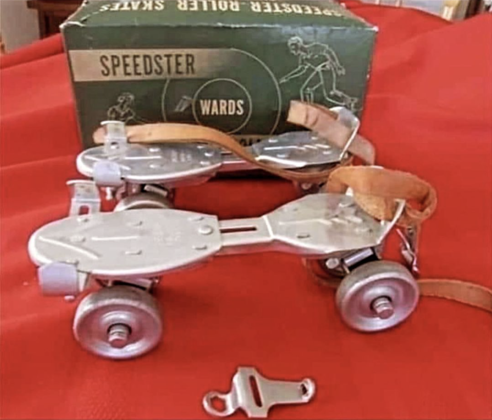 Vintage Ward's Speedster roller skates with metal frames and leather straps in front of a green box that reads "Speedster Roller Skates."