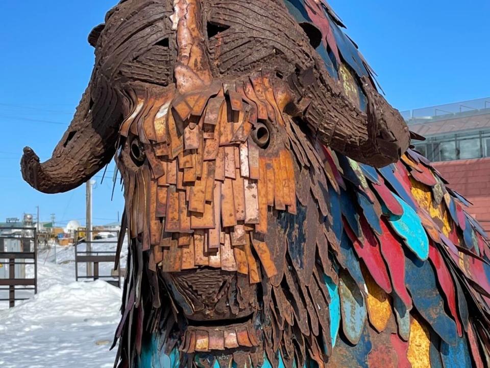 This muskox made from recycled iron by young people at the Red Fish studio stands in the Cambridge Bay's heritage park. The community's spring festival honours the large animal. (Jane George/CBC - image credit)