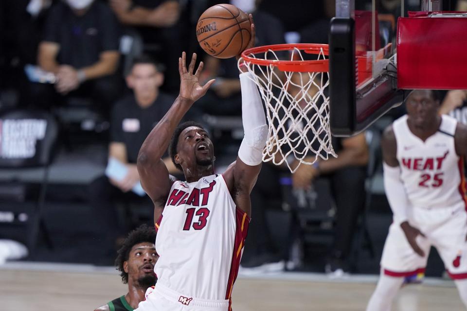 Miami Heat forward Bam Adebayo (13) goes up for a shot after getting past Boston Celtics guard Marcus Smart, left rear, during the first half of an NBA conference final playoff basketball game, Thursday, Sept. 17, 2020, in Lake Buena Vista, Fla. (AP Photo/Mark J. Terrill)