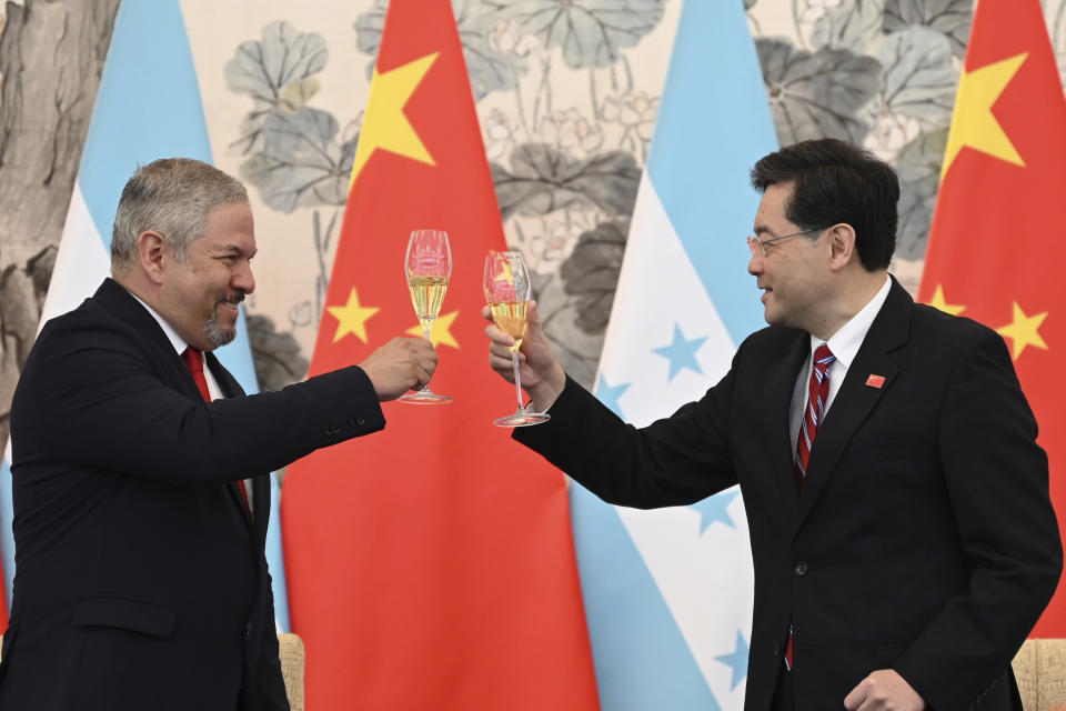 Honduras Foreign Minister Eduardo Enrique Reina Garcia, left, and Chinese Foreign Minister Qin Gang, raise a toast following the establishment of diplomatic relations between the two countries, at a ceremony in the Diaoyutai State Guesthouse in Beijing, Sunday, March 26, 2023. Honduras formed diplomatic ties with China on Sunday after breaking off relations with Taiwan, which is increasingly isolated and now recognized by only 13 sovereign states. (Greg Baker/Pool Photo via AP)
