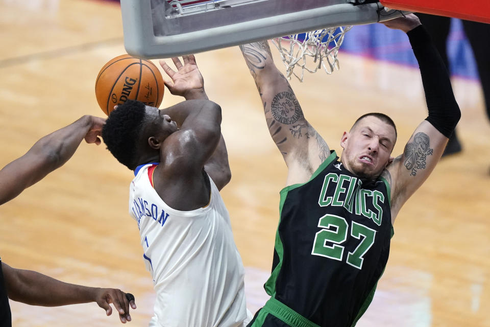 New Orleans Pelicans forward Zion Williamson is stripped of the ball as he drives to the basket against Boston Celtics center Daniel Theis (27) in the first half of an NBA basketball game in New Orleans, Sunday, Feb. 21, 2021. (AP Photo/Gerald Herbert)