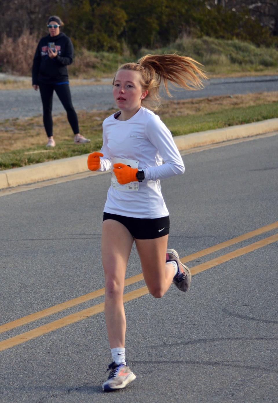 Caroline Matthews reaches the 1-mile mark on her way to the women's title at HCC Turkey Trot 5K.