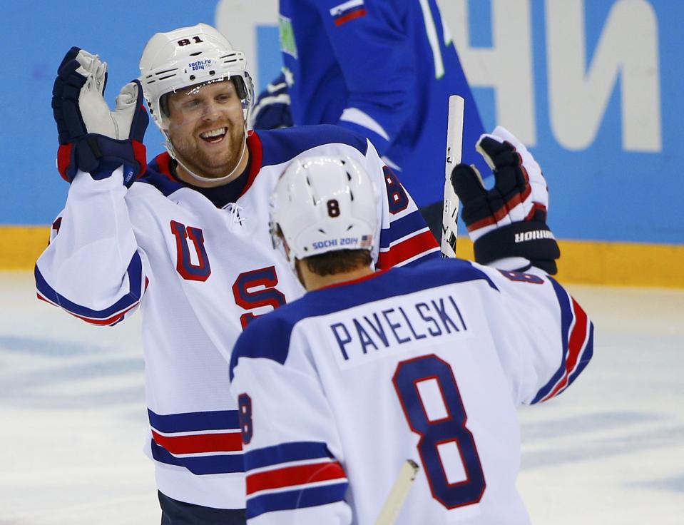 Team USA's Phil Kessel is congratulated by teammate Joe Pavelski after scoring on Slovenia during the first period of their men's preliminary round ice hockey game at the 2014 Sochi Winter Olympics, February 16, 2014. REUTERS/Brian Snyder (RUSSIA - Tags: OLYMPICS SPORT ICE HOCKEY TPX IMAGES OF THE DAY)