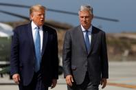 U.S. President Trump walks with new national security adviser O'Brien at Los Angeles International Airport in Los Angeles California