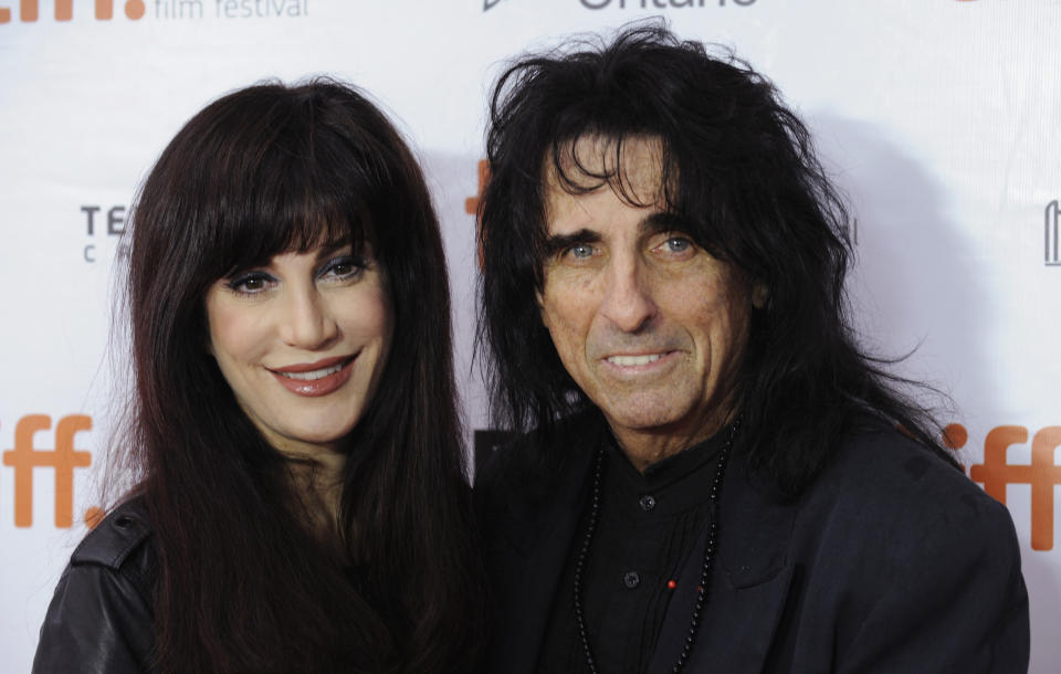 Cast member Alice Cooper (R) and wife Sheryl Goddard pose on the red carpet before a screening of the film "Supermensch: The Legend of Shep Gordon" at Roy Thomson Hall during the 38th Toronto International Film Festival in Toronto September 7, 2013.   REUTERS/Jon Blacker (CANADA - Tags: ENTERTAINMENT)