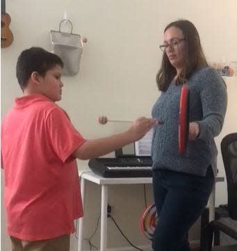 Music therapist Kimberly Haffey (right) uses music as a guide to help Eli Verilli develop his motor skills by using instruments functionally. The instruments help Eli to stay focused and express himself more effectively.