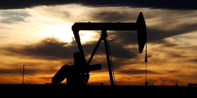 FILE PHOTO: The sun sets behind a crude oil pump jack on a drill pad in the Permian Basin in Loving County, Texas, U.S. November 24, 2019. Picture taken November 24, 2019.  REUTERS/Angus Mordant