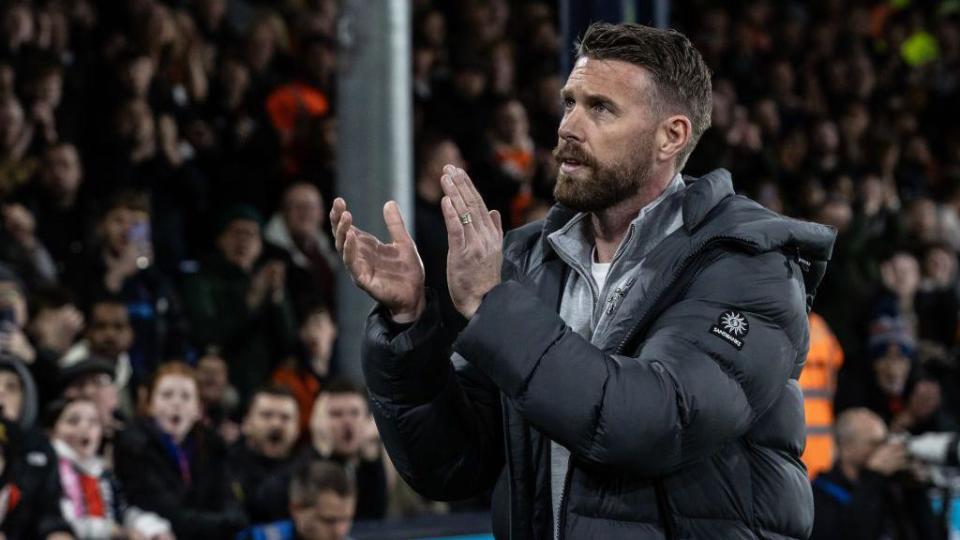 Luton Town's manager Rob Edwards applauds his side's supporters