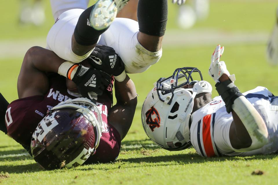 Texas A&M wide receiver Ainias Smith, left, is tackled by Auburn's Ladarius Tennison after calling for a fair catch on a punt during their game last November. Smith has been suspended from the team after a recent arrest.