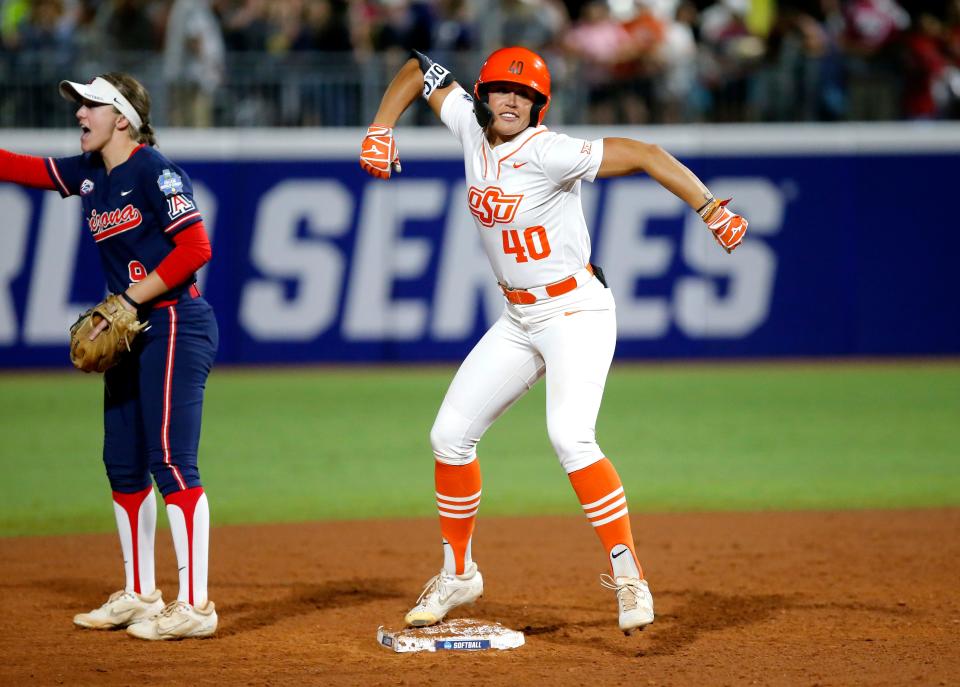 Oklahoma State's Miranda Elish (40) celebrates a double in the fourth inning next to Arizona's Allie Skaggs (9) on Thursday.