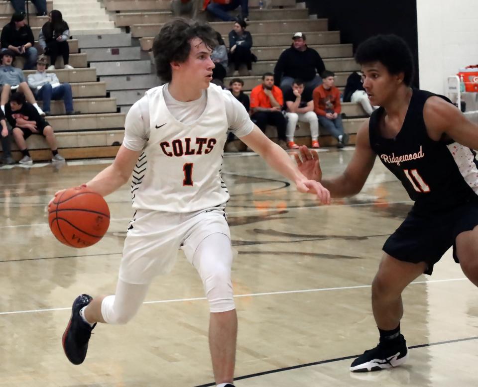 Meadowbrook's Michael Ray (1) dribbles the ball during the Colts versus Generals basketball game Tuesday evening at Meadowbrook High School.