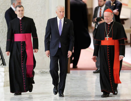 U.S. Vice President Joe Biden (C) walks next to cardinal Gianfranco Ravasi (R) in Paul VI hall at the Vatican April 29, 2016. REUTERS/Max Rossi