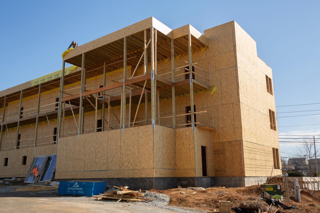 A builder continues work on a new residential structure at the Arden Village Community in Columbia, Tenn., on Wednesday, Feb. 9, 2022. 