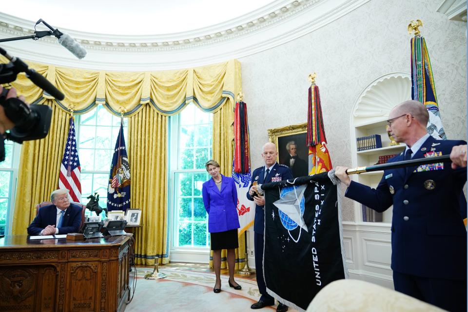 (L-R) US President Donald Trump, Secretary of the Air Force Barbara Barrett, US Space Force Chief of Space Operations Gen. Jay Raymond and US Space Force Senior Enlisted Advisor CMSgt Roger Towberman present the US Space Force Flag on May 15, 2020, in the Oval Office of the White House in Washington, DC. (Photo by MANDEL NGAN / AFP) (Photo by MANDEL NGAN/AFP via Getty Images)