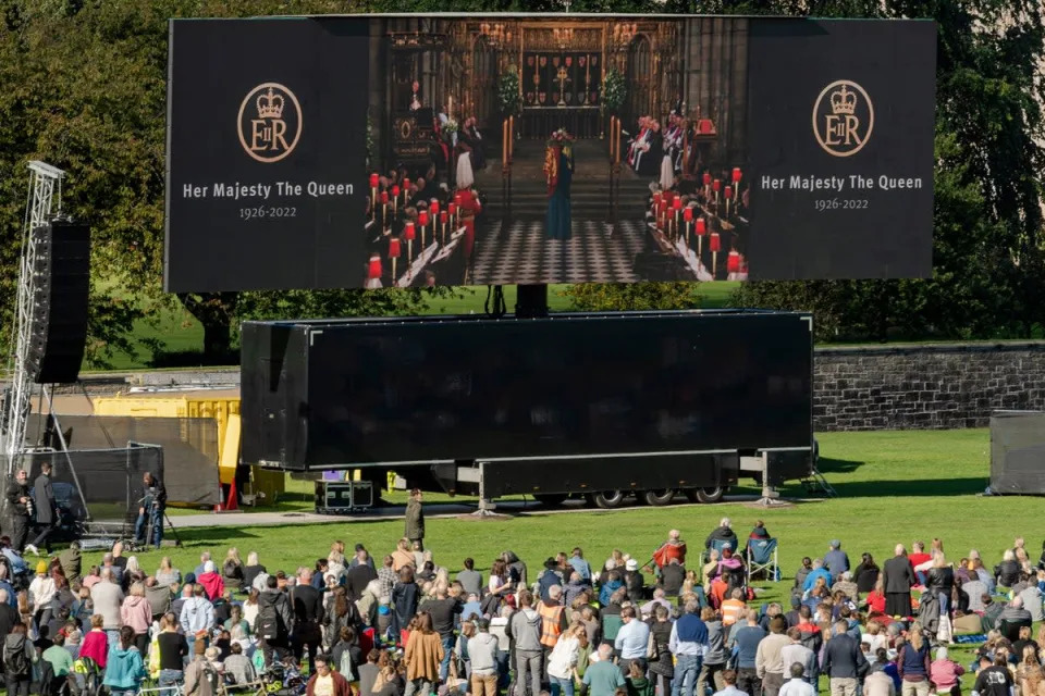 Members of the public watch Queen Elizabeth II’s state funeral on a tv screen in Holyrood Park, Edinburgh (Getty Images)