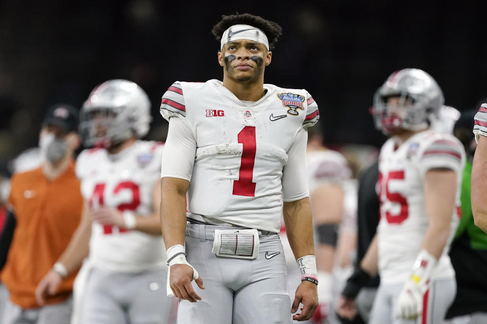 FILE -= Ohio State quarterback Justin Fields watches during the second half of the Sugar Bowl NCAA college football game against Clemson Friday, Jan. 1, 2021, in New Orleans. Fields is a likely first round pick in the NFL Draft, April 29-May 1, 2021, in Cleveland.(AP Photo/John Bazemore, File)