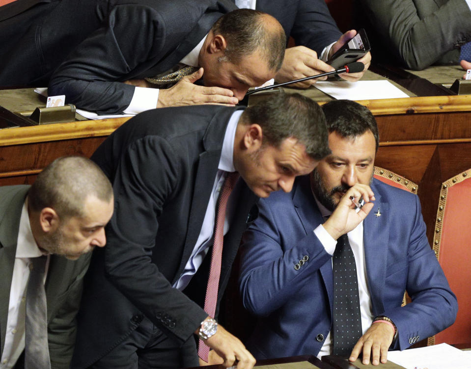 Italian Interior Minister and Deputy-Premier Matteo Salvini, right, sits beside Agricultural Minister and The League's lawmaker Gian Marco Centinaio as he addresses the Senate in Rome, Tuesday, Aug. 13, 2019. Italy’s political leaders scrambled to line up allies and form alliances Tuesday as the country’s right-wing interior minister pressed his demands for an early election in the hope of snagging the premiership as a platform for his anti-migrant, euroskeptic agenda. Senators hastily summoned back from a vacation break convened for a vote on scheduling their consideration of a no-confidence motion lodged by Matteo Salvini’s League party against Premier Giuseppe Conte’s 14-month-old populist government. (AP Photo/Alberto Pellaschiar)