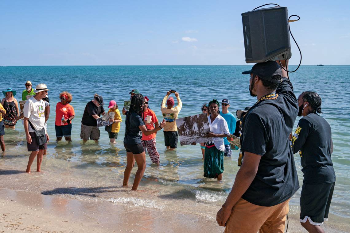 People sing during a symbolic ‘wade-in’ at Historic Virginia Key Beach Park in Miami on Saturday, Nov. 12, 2022.