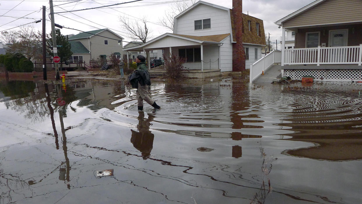 My husband Steve Chin in waders on our block Utica Walk in Breezy Point which  suffered severe damage by Hurricane Sandy. Queens, NY (Debbie Egan-Chin/NY Daily News via Getty Images)