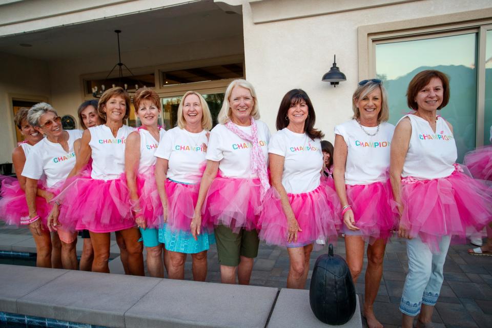 The Mixed Housewives of Del Webb, a group of women in the Del Webb neighborhood, smile in their pink tutus in Rancho Mirage, Calif., on Tuesday, October 4, 2022. The group fundraises for the Desert Cancer Foundation and plan to participate in the 16th Annual Paint El Paseo Pink breast cancer awareness walk. 