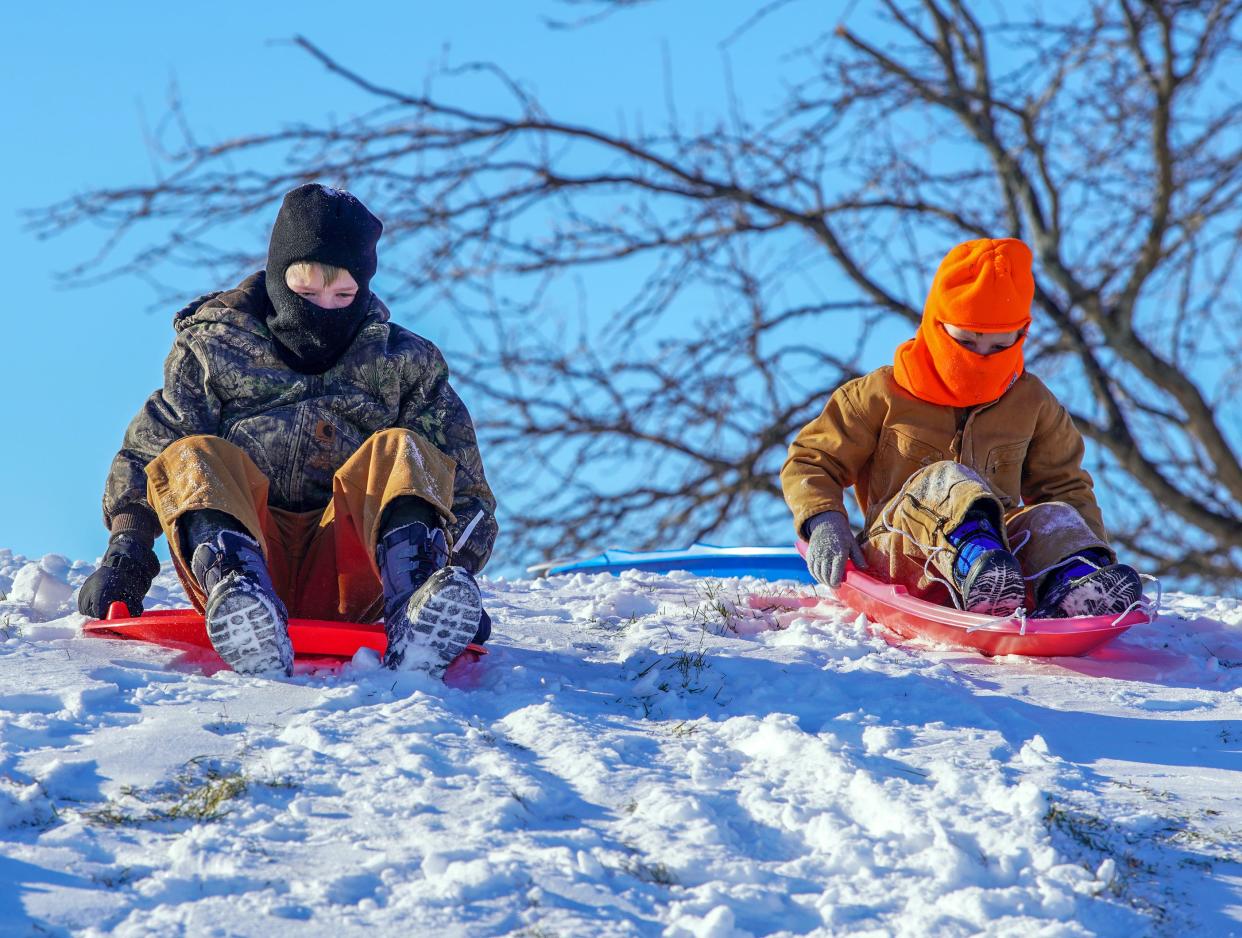 Logan Gaither, 9, left, and younger brother Sawyer Gaither, 6, prepare to sled down the hill Sunday afternoon at Rotary Park. Temperatures were 0 degrees at the time but that didn’t deter several families from enjoying the fresh 5.9 inches of snow Galesburg received Saturday. Some families also made use of the freely available borrow/return sleds courtesy of the City of Galesburg Parks & Recreation Division.