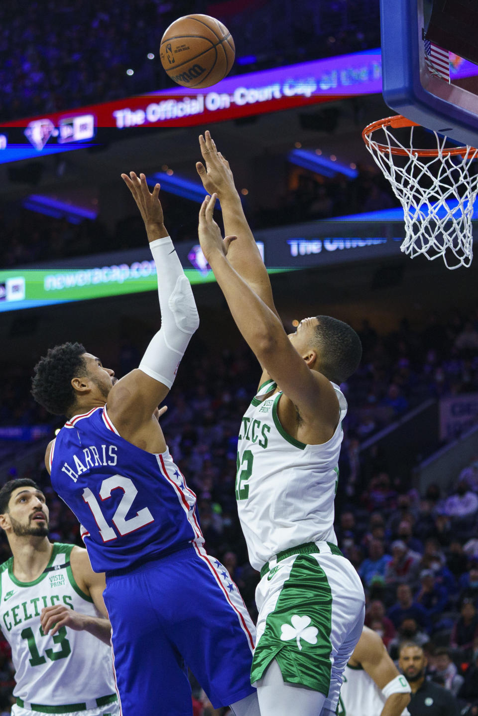 Philadelphia 76ers' Tobias Harris, left, puts up the shot against Boston Celtics' Grant Williams, right, during the first half of an NBA basketball game, Friday, Jan. 14, 2022, in Philadelphia. (AP Photo/Chris Szagola)