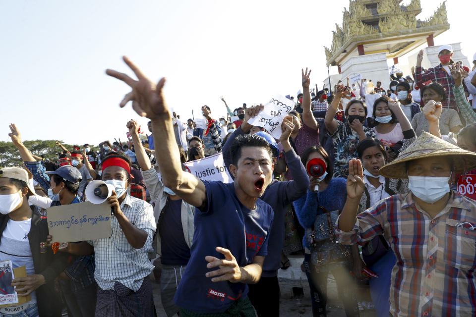 Demonstrators flash a three-fingered symbol of resistance against the military coup and shout slogans calling for the release of detained Myanmar State Counselor Aung San Suu Kyi during a protest in Mandalay, Myanmar on Wednesday, Feb. 10, 2021. Protesters continued to gather Wednesday morning in Mandalay breaching Myanmar's new military rulers' decrees that effectively banned peaceful public protests in the country's two biggest cities. (AP Photo)
