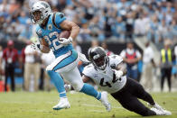 Carolina Panthers running back Christian McCaffrey (22) runs for a tuchdown as Jacksonville Jaguars middle linebacker Myles Jack (44) reaches during the first half of an NFL football game in Charlotte, N.C., Sunday, Oct. 6, 2019. (AP Photo/Brian Blanco)