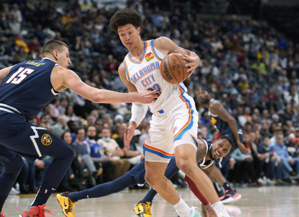 Oklahoma City Thunder forward Isaiah Roby as Denver Nuggets center Nikola Jokic, left, and guard Monte Morris defend during the first half of an NBA basketball game Wednesday, March 2, 2022, in Denver. (AP Photo/David Zalubowski)