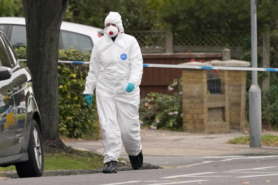 A forensic officer arrives to enter the Belfairs Methodist Church where a member of Parliament was killed on Friday, in Eastwood Road North, in Leigh-on-Sea, Essex, England, Saturday, Oct. 16, 2021. David Amess, a long-serving member of Parliament was stabbed to death during a meeting with constituents at a church in Leigh-on-Sea on Friday, in what police said was a terrorist incident. A 25-year-old man was arrested in connection with the attack, which united Britain's fractious politicians in shock and sorrow. (AP Photo/Alberto Pezzali)