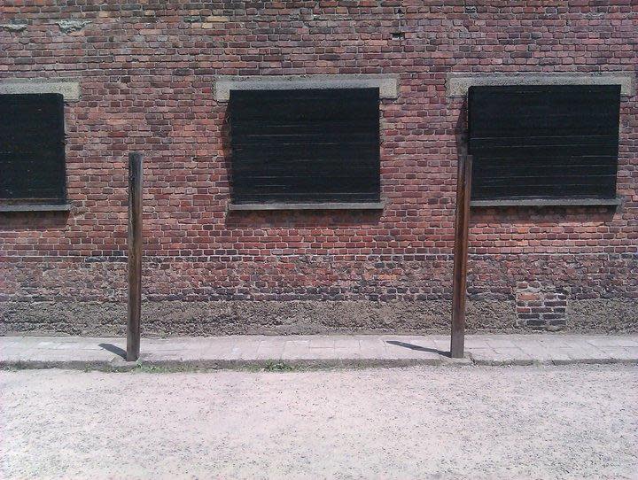 Notice the barricaded windows around the death wall. Sounds are a more potent deterrent than seeing the killings. The two poles are from which victims were tied before execution. Photo: Amandeep Sandhu