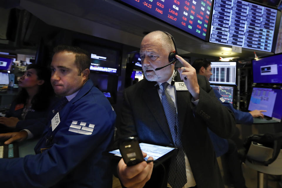 Specialist Gennaro Saporito, left, and trader Robert Moran work on the floor of the New York Stock Exchange, Thursday, July 18, 2019. U.S. stocks moved lower in early trading on Wall Street Thursday after Netflix reported a slump in new subscribers and dragged down communications companies. (AP Photo/Richard Drew)