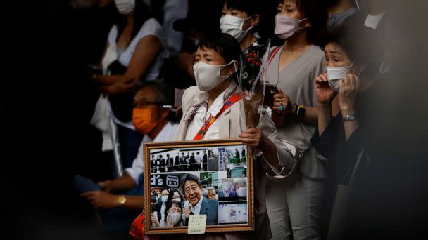 PHOTO: People wait for end of the funeral of late former Japanese Prime Minister Shinzo Abe outside Zojoji temple, in Tokyo, Japan, on July 12, 2022. (Issei Kato/Reuters)