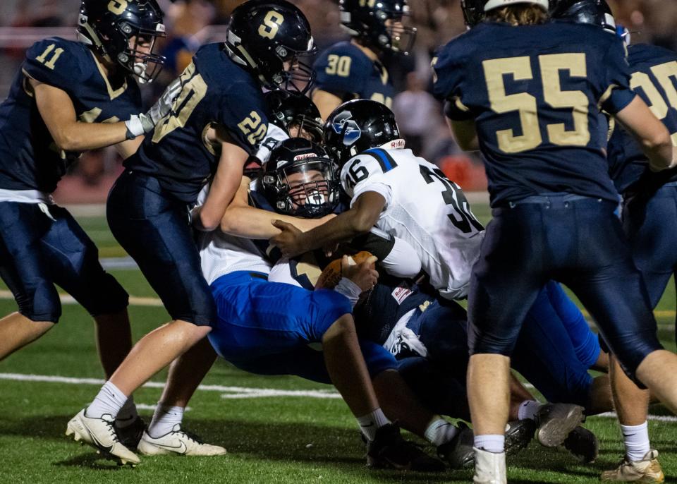 Council Rock South linebacker Caleb Christian, center, is brought down by Central Bucks South linebacker Sean Moskowitz, left, and running back Corey Moore, on Thursday, October 7, 2021, at Walt Snyder Stadium in Newtown Borough. The Titans defeated the Golden Hawks, 38-14.