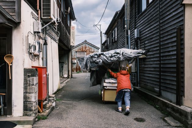 A vendor closes up her stall and wheels it away for the day at the Wajima Morning Market on Noto Peninsula.