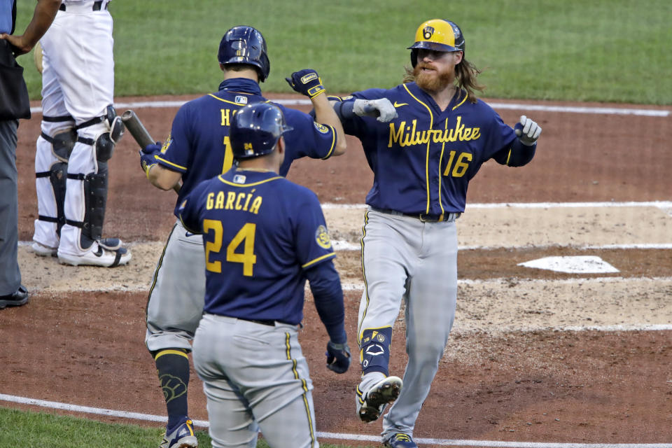 Milwaukee Brewers' Ben Gamel (16) celebrates with Brock Holt (11) and Avisail Garcia (24) after hitting a two-run home run off Pittsburgh Pirates starting pitcher Joe Musgrove during the third inning of a baseball game in Pittsburgh, Wednesday, July 29, 2020. (AP Photo/Gene J. Puskar)