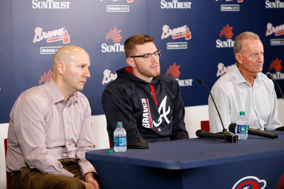 Atlanta’s former GM John Coppolella, left, is banned for life from baseball for the illegal signing of 13 international players.