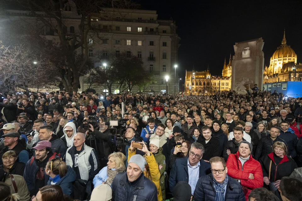 People listen to the speech of former Hungarian government insider Peter Magyar next to Kossuth Square on Tuesdy, in Budapest, Hungary, March 26, 2024. Magyar on Tuesday released a recording that he claims proves senior officials in the government of Prime Minister Viktor Orban manipulated court documents to cover up their involvement in a corruption case. (AP Photo/Denes Erdos)