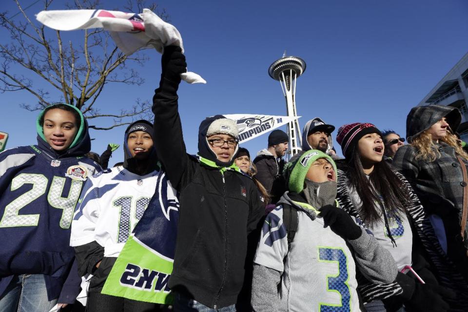 Seattle Seahawks fans cheer as they wait for the Seahawks' Super Bowl victory parade to begin Wednesday, Feb. 5, 2014, in Seattle. The Seahawks beat the Denver Broncos 43-8 on Sunday. (AP Photo/Elaine Thompson)