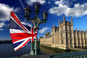 houses of parliament with flag...