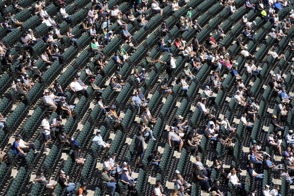 Fans watch the third inning of a baseball game between the Chicago White Sox and the Los Angeles Angels, Thursday, Sept. 26, 2024, in Chicago. (AP Photo/Charles Rex Arbogast)