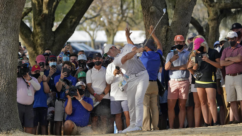 Rory McIlroy, of Northern Ireland, hits from the rough along the 16th fairway during the second round of the Arnold Palmer Invitational golf tournament Friday, March 5, 2021, in Orlando, Fla. (AP Photo/John Raoux)