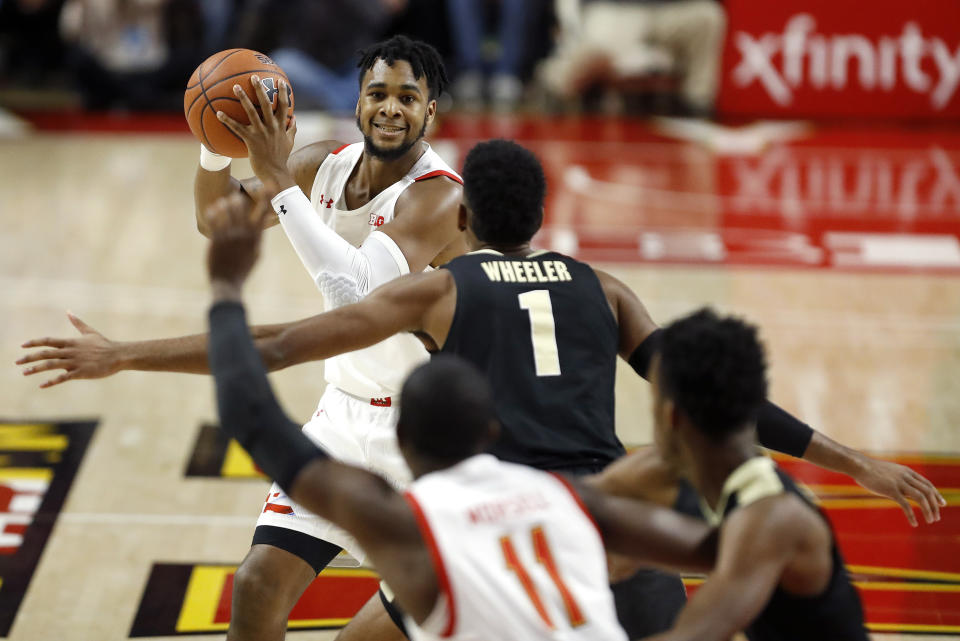 Maryland forward Donta Scott, top, looks for an open teammate against Purdue during the first half of an NCAA college basketball game, Saturday, Jan. 18, 2020, in College Park, Md. (AP Photo/Julio Cortez)