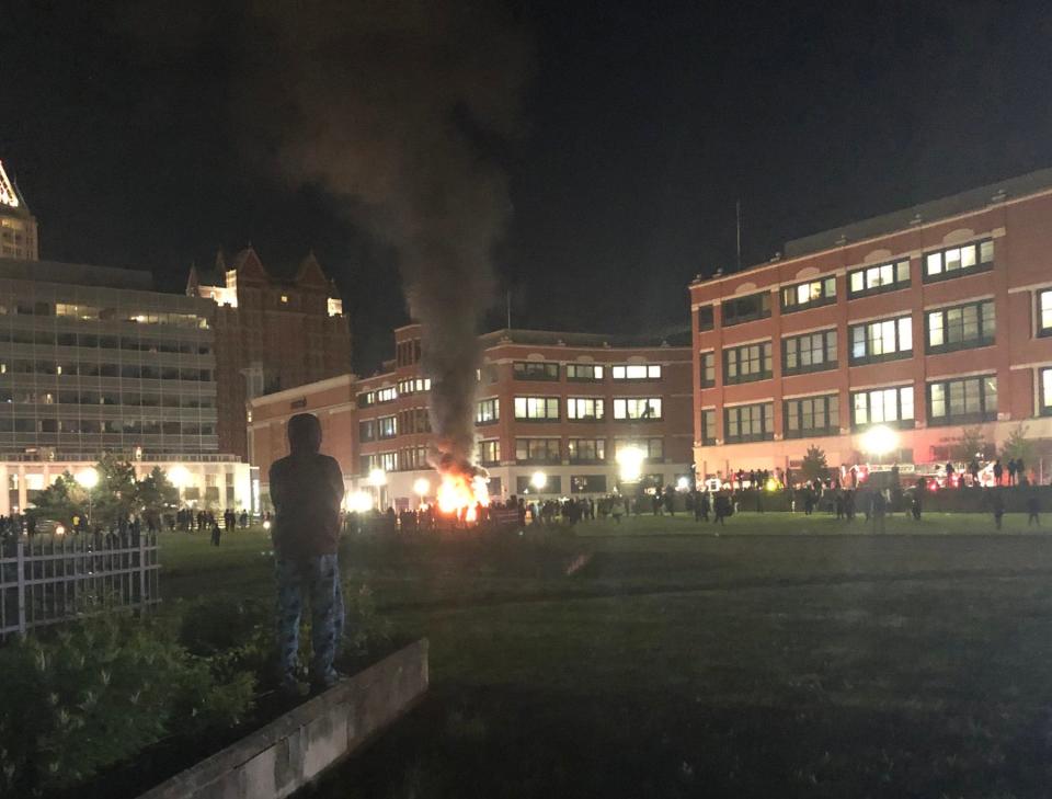 Flames and a plume of smoke rise from a police cruiser set ablaze in front of Providence Place in the early hours of June 3, 2020.