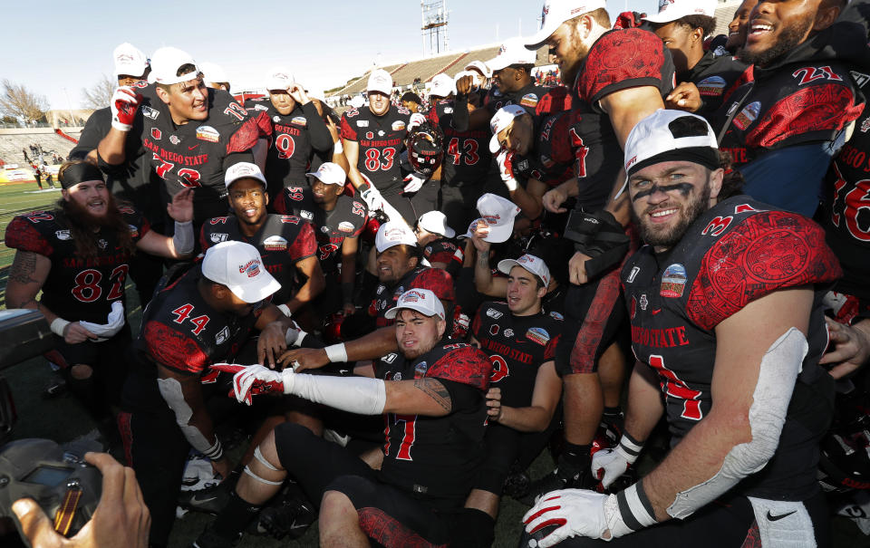 San Diego State football players celebrate after they beat Central Michigan in the New Mexico Bowl NCAA college football game on Saturday, Dec. 21, 2019 in Albuquerque, N.M. (AP Photo/Andres Leighton)