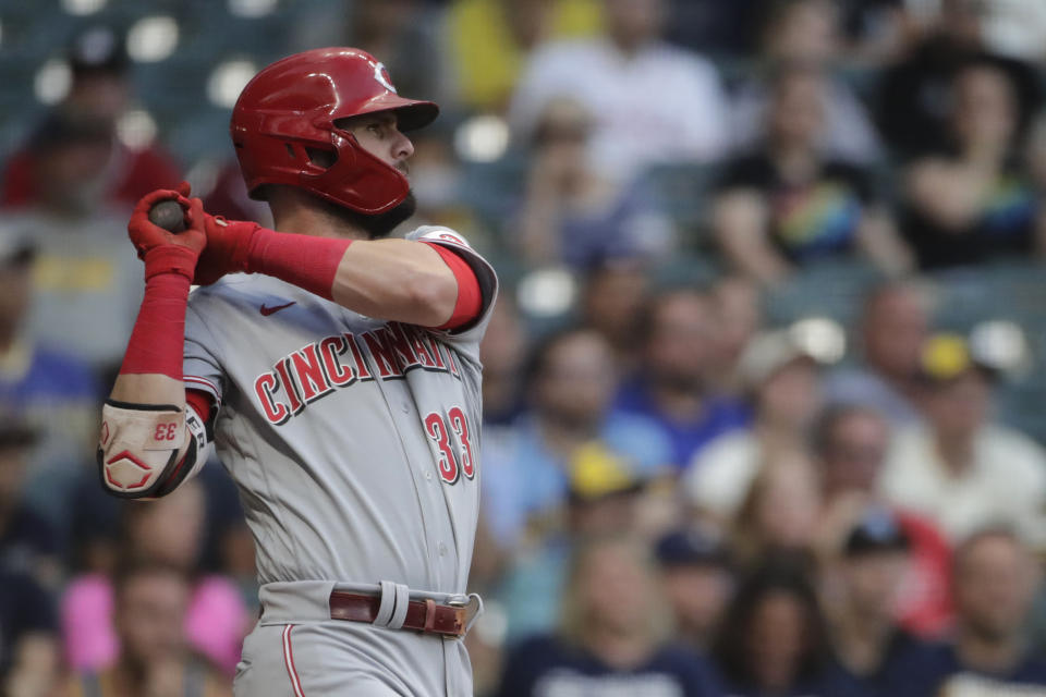 Cincinnati Reds' Jesse Winker hits an RBI-single during the second inning of a baseball game against the Milwaukee Brewers, Monday, June 14, 2021, in Milwaukee. (AP Photo/Aaron Gash)