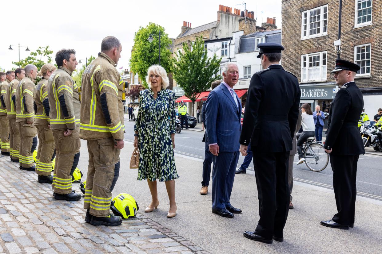 Britain's Prince Charles, Prince of Wales and Britain's Camilla, Duchess of Cornwall meet firefighters outside Clapham Fire Station during their visit to Clapham Old Town, south London on May 27, 2021. (Photo by Heathcliff O'Malley / POOL / AFP) (Photo by HEATHCLIFF O'MALLEY/POOL/AFP via Getty Images)