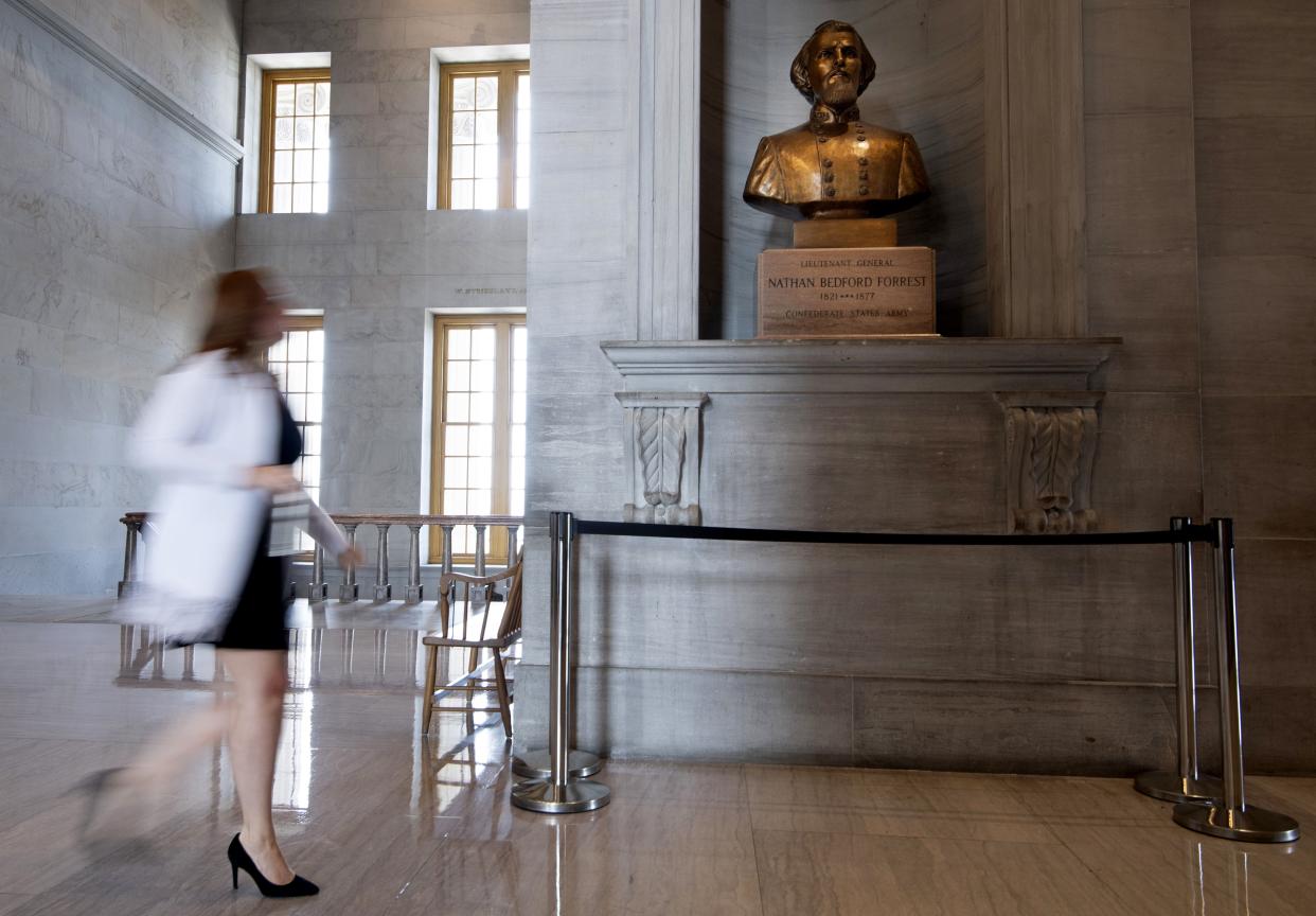 A capitol employee walks past a bust of Confederate general and early Ku Klux Klan leader Nathan Bedford Forrest at the State Capitol Thursday in Nashville, Tenn.