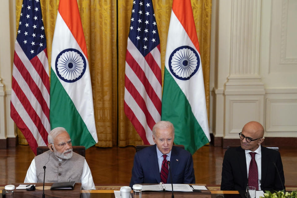 President Joe Biden speaks during a meeting with India's Prime Minister Narendra Modi and American and Indian business leaders in the East Room of the White House, Friday, June 23, 2023, in Washington. Satya Nadella, CEO of Microsoft, listens at right. (AP Photo/Evan Vucci)