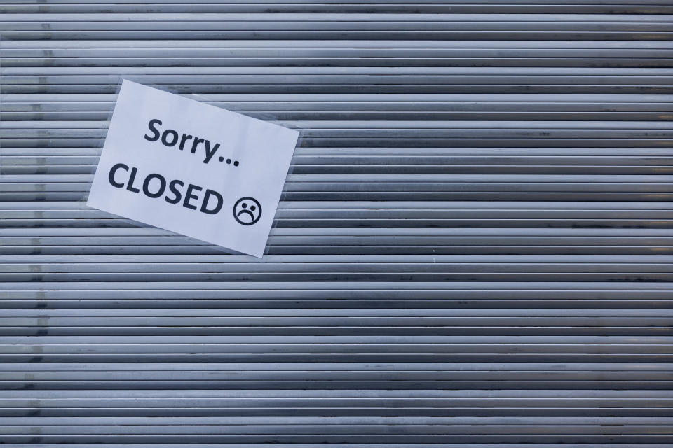 "Sorry Closed" is written on a piece of paper stuck to the lowered shutter of a closed snack bar in Muenster, Germany, Tuesday, Nov.3, 2020. A four-week partial lockdown has begun throughout Germany on 02.11.2020 to slow down the spread of the corona virus. (Rolf Vennenbernd/dpa via AP)